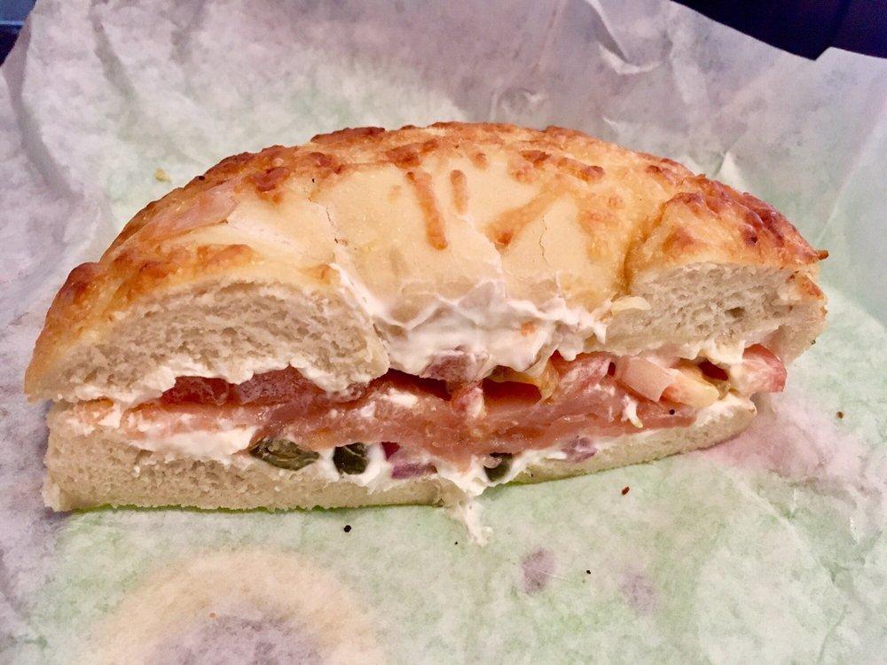 Nova Lox Sandwich · Lox with plain cream cheese, red onions and tomatoes on a toasted bagel (capers optional).