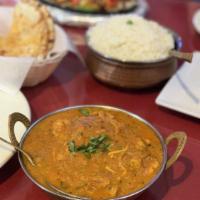 Chicken Curry · With an exotic blend of spice onion, garlic, ginger and tomato with medium curry sauce.