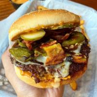 Jose Mendoza Burger · Bacon, roasted green chiles, monterey jack, house sauce, grilled onion and pickle. Every bur...