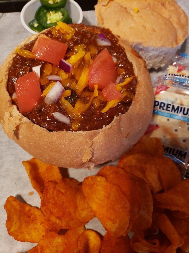 Chili · A thick, rich beef based chili with onions, green peppers, tomatoes, jalapenos, spices and just enough heat. Served in a bread bowl and topped with cheddar cheese.