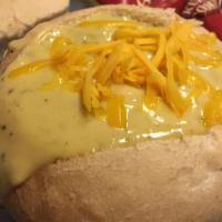 Broccoli Cheese Soup · A light and delicate soup loaded with bits of broccoli, cheese and spices. Served in a bread...
