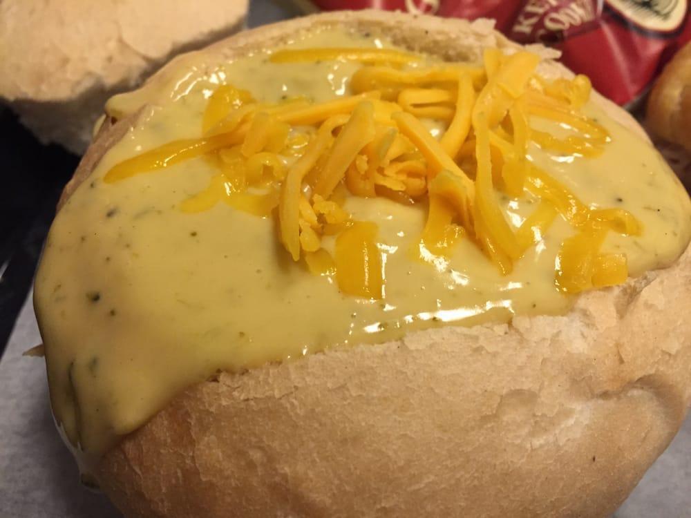 Broccoli Cheese Soup · A light and delicate soup loaded with bits of broccoli, cheese and spices. Served in a bread bowl and topped with cheddar cheese.