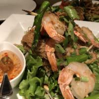 Sen Mee Prawns · Marinated prawns grilled, served over noodles and green leaf. Topped with onion, cilantro an...