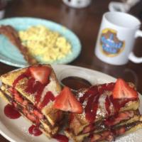French Toast · Three slices of white bread cut in half, topped with seasonal fruit, poiwdered sugar and whi...