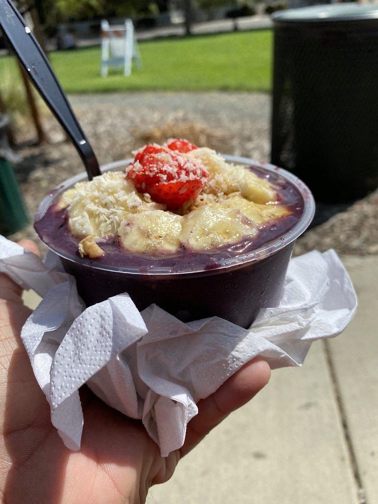 Acai Bowl · Bowl made with purple poodle smoothie, organic granola, strawberries, banana, honey and coconut flakes healthy option - perfect for breakfast, lunch or snack time. Vegan.