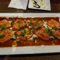 Salmon Carpaccio · Lightly pounded salmon, shallot, cilantro, capers, satl and pepper. Served with olive oil an...