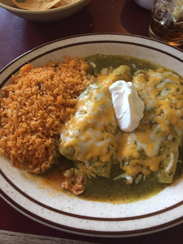 Enchilada Suiza · 2 corn tortillas stuffed with your choice of filling. Topped with a delicious green tomatillo sauce and melted cheese, garnished with sour cream.