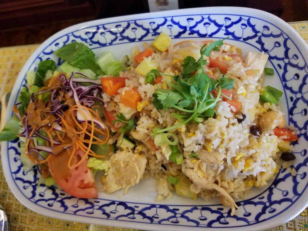 Pineapple Fried Rice · Thai style fried rice cooked with pineapples, cashew nuts, raisins, and mixed vegetables. 