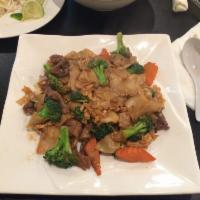 Pad See Ew · Chicken, pork or tofu. Stir-fried wide rice noodles with broccoli, carrots, egg and soy sauc...