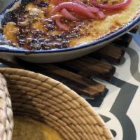 Queso Fundido · A tasty typical dish with melted Oaxaca cheese, rajas poblanas, and Mexican chorizo, topped ...