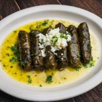 Dawali · Rolled grape leaves stuffed with rice, chickpeas, tomatoes, and parsley, topped with Aladdin...