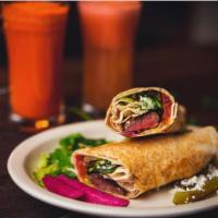 Aladdin's Lamb Rolled · Grilled lamb seasoned with herbs and spices, topped with tomatoes, onions, greens, turnips, ...