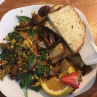 Vegan Scramble Breakfast · Organic tofu, mushrooms, red pepper, onions and organic baby spinach served with a side of p...