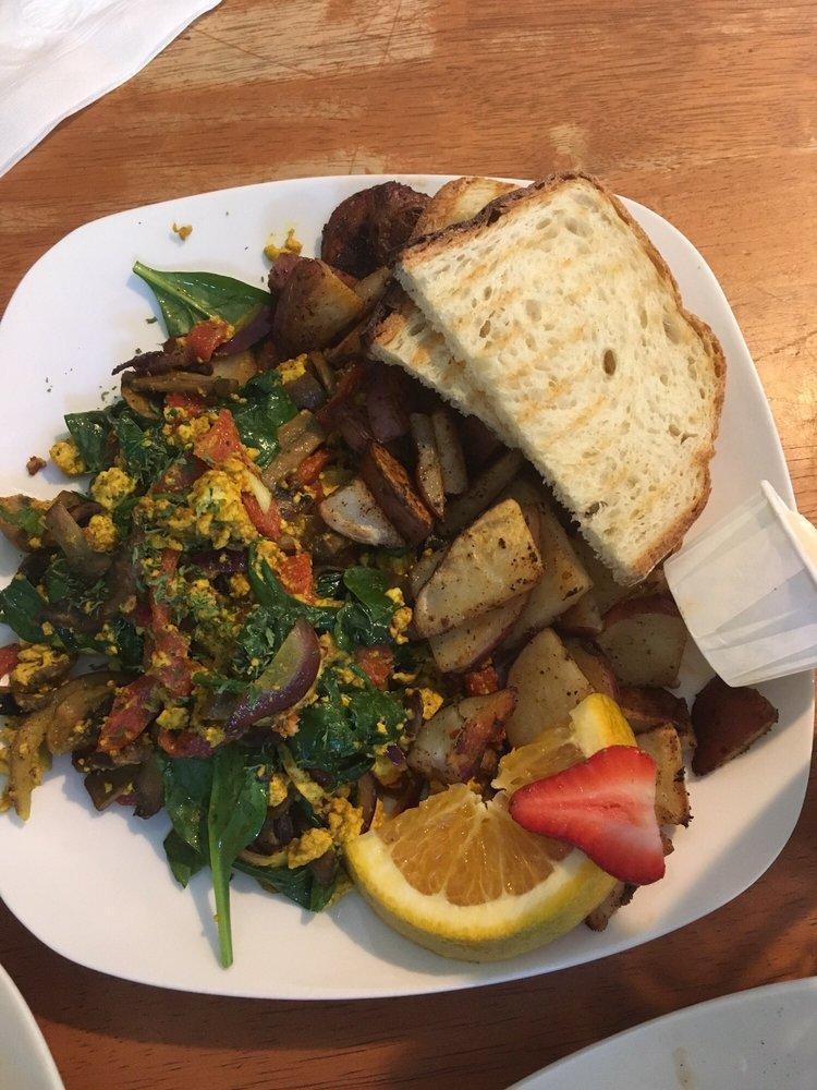 Vegan Scramble Breakfast · Organic tofu, mushrooms, red pepper, onions and organic baby spinach served with a side of potatoes and toast.