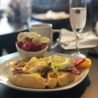 Bacon Waffle Benedict Breakfast · 2 poached eggs, 2 slices of bacon on a scratch made waffle smothered in house made hollandai...