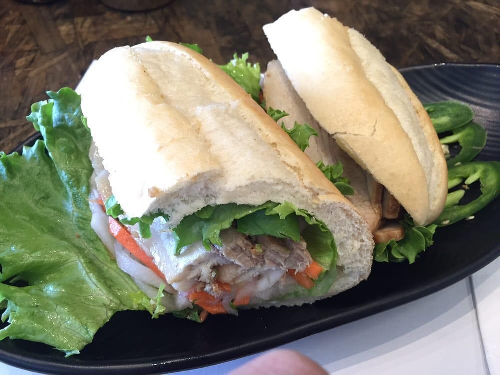 Roasted Pork Belly Banh Mi · French bread, cilantro, green leaf, pickled daikon and carrot.