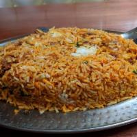Lamb Biryani · Long grain basmati rice cooked with tender lamb cubes and authentic spices, garnished with n...