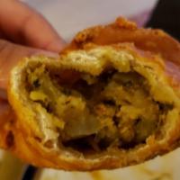 Vegetable Samosa · Crispy patties stuffed with potatoes and peas, lightly seasoned with spices. Served with tam...