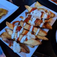 Caribbean Potato Wedges · Freshly cut russet potatoes cooked to perfection. Topped with ketchup and our signiture sofr...
