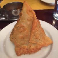 Vegetable Samosa · 1 piece. Triangular shaped crispy turnovers filled with potatoes and green peas.