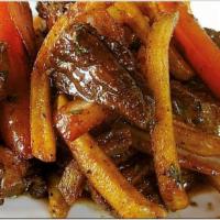 Lomo Saltado · Marinated tender steak meat sauteed in olive oil with tomatoes, red onions, cilantro white r...