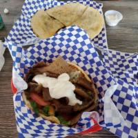 Gyro Wrap · Thinly sliced beef and lamb meat served on a warm pita topped with tzatziki sauce, lettuce, ...