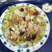 Greek Salad · Lettuce, olives, tomatoes, cucumber, onions topped with crumbled feta cheese. Tomatoes, cucu...