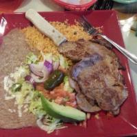 Carne Asada · Our special recipe grilled steak. Garnished with lettuce tomato, onion, avocado, jalapeno an...