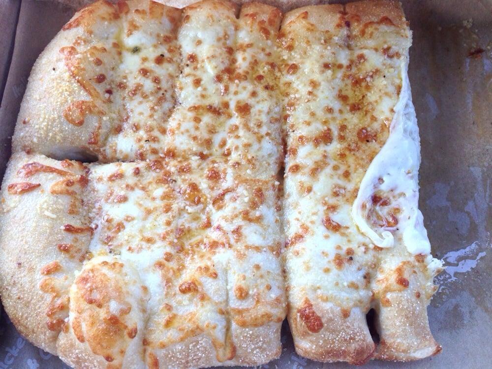 Cheezybread · Fresh-baked bread strips with our signature three cheeses and garlic sauce, served with a side of our original pizza sauce and ranch dipping sauce