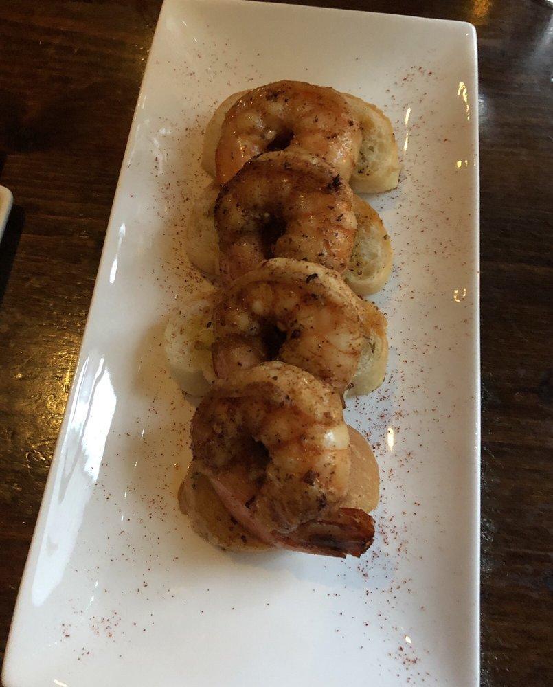 Angry Garlic Shrimp · Pan seared jumbo shrimp with lemon, garlic slices and rosemary. Served over toasted bread.