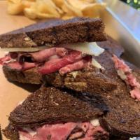 Pastrami Ruben · Shaved pastrami, cabbage kraut and Swiss cheese with 1000 island dressing pressed on dark so...