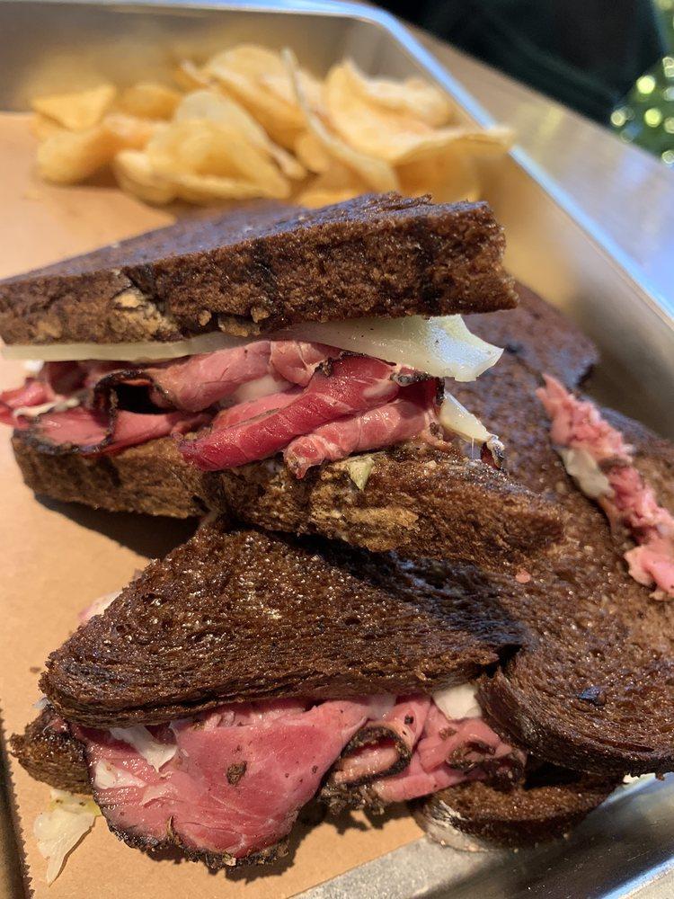 Pastrami Ruben · Shaved pastrami, cabbage kraut and Swiss cheese with 1000 island dressing pressed on dark sourdough rye.