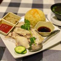 Hainan Chicken Rice · Steamed chicken served with ginger rice, cooked in broth and ginger.