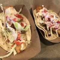 Original Crispy Fish Taco · Baja style fish taco, served on corn tortillas and topped with shredded cabbage, pico de gal...