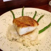Pan Seared Chilean Sea Bass · Over a sweet pea and fresh horseradish risotto, asparagus spears and balsamic beurre rouge.