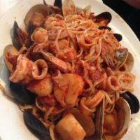 Seafood Linguine · Served with littleneck clams, mussels, calamari, shrimp and scallops in a light tomato sauce.