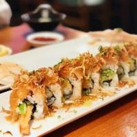 Dragon Roll · Inside: shrimp tempura, cucumber top: eel, avocado sauce: eel.