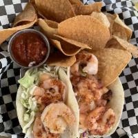 Shrimp Tacos · Blackened shrimp, seasoned slaw, pineapple pico, and lime crema.