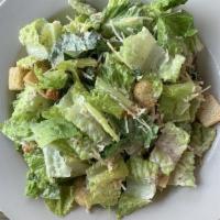 Caesar Salad · Fresh romaine tossed in housemade Caesar dressing, topped with Parmesan and croutons.