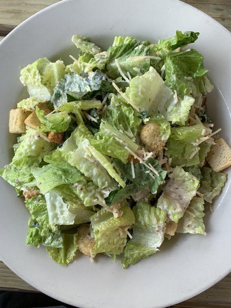 Caesar Salad · Fresh romaine tossed in housemade Caesar dressing, topped with Parmesan and croutons.