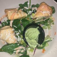Avocado Roll · Freshly sliced avocado, black beans, and roasted corn, wrapped in a flour tortilla and deep-...