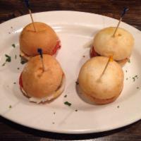 Meatball Sliders · Meatball halves served in slider bun topped with a lite tomato sauce & pecorino romano.