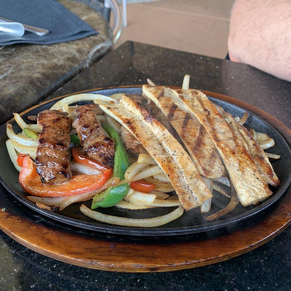 Fajitas · All fajitas served sizzling on a bed of grilled onions and grilled bell peppers. Served with rice, beans, guacamole, pico de gallo and sour cream.  Add cheese for an additional charge.