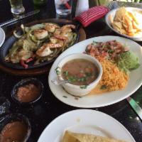 Shrimp Fajitas · Seven jumbo shrimp sizzling on a bed of onions and grilled peppers. Cooked with white wine, ...