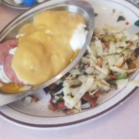 Eggs Benedict Breakfast · 2 poached eggs and Canadian bacon on an English muffin. Topped with hollandaise sauce. Serve...