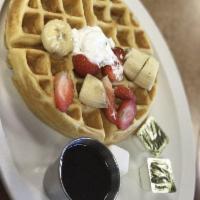 Belgian Waffle · Topped with sliced strawberries, sliced bananas, and whipping cream.