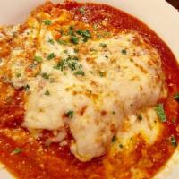 Lasagna · Layers of ground beef and ricotta cheese, baked mozzarella.