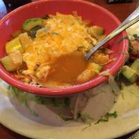Tortilla Soup · Seasoned shredded chicken, Spanish rice, vegetables, grated cheeses and pico de gallo topped...