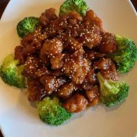 Sesame Chicken · Crispy breaded chicken showered with sesame seeds sauce served with broccoli.