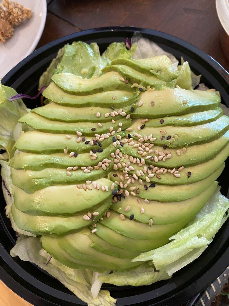 Avocado Salad · Sliced avocado on top of lettuce with ginger dressing.